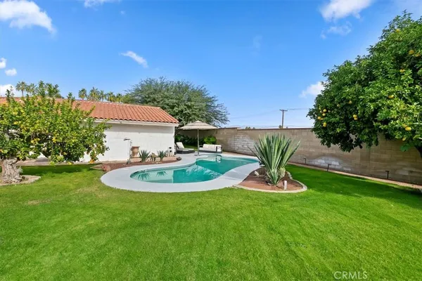 a backyard of a house with a yard and outdoor seating