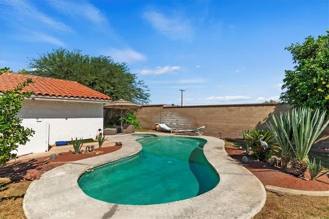 a view of a swimming pool with an outdoor seating