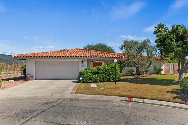 a view of a house with palm trees