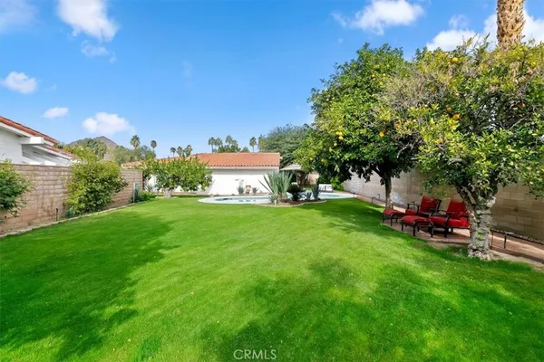 a view of a patio with table and chairs potted plants with wooden fence