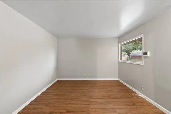 a view of room with wooden floor and window