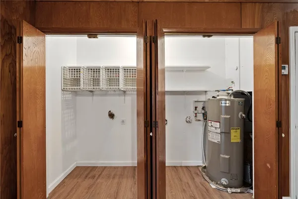 a view of a hallway with wooden floor and entryway