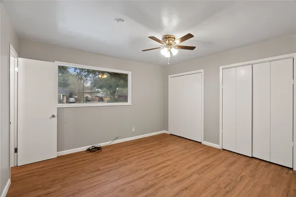 a view of empty room with wooden floor
