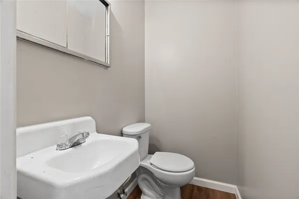 a bathroom with a sink a toilet and a mirror