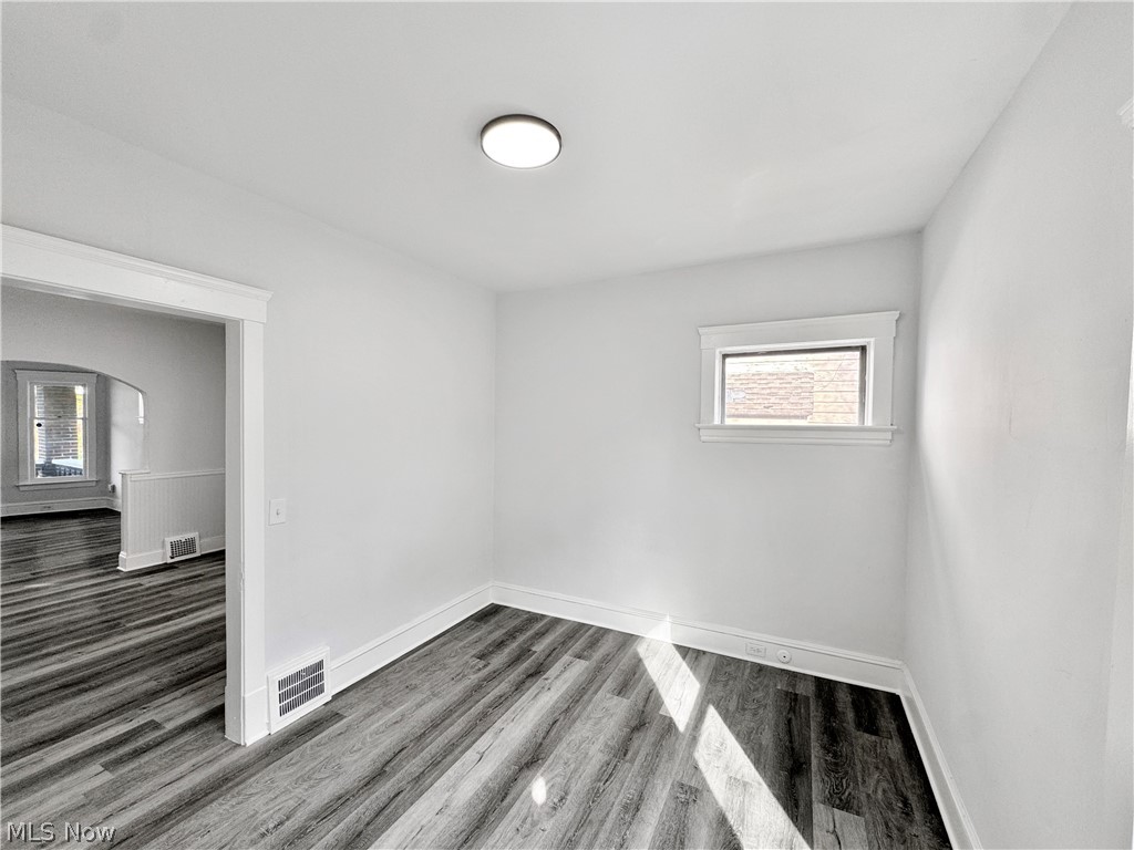 977 Nathaniel Road Cleveland, OH 44110 - Photo 13 of 22 Interior room featuring wood-finish flooring, white walls, and a recessed ceiling light fixture