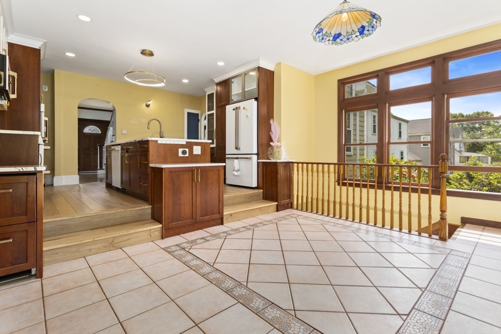 29 Boulevard Road Dedham, MA 02026 - Photo 7 of 34 a view of a kitchen with furniture and large windows