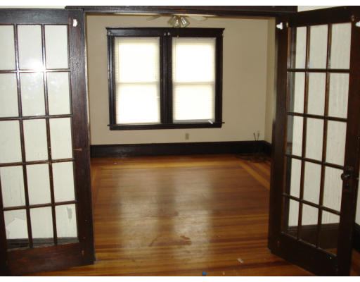 808 Elm Street Woonsocket, RI 02895 - Photo 7 of 7 a view of an empty room with wooden floor and a window