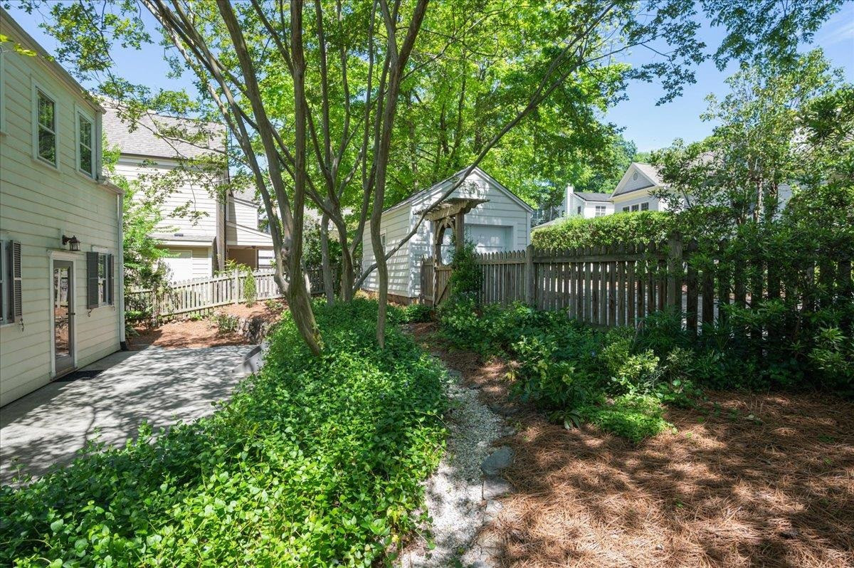 2511 Kenmore Drive Raleigh, NC 27608 - Photo 29 of 34 English inspired landscape/gardens off entertaining private patio and walk ways Exterior Back