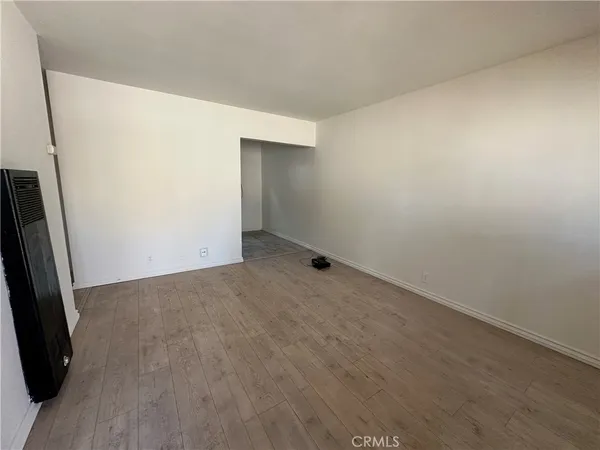 an empty room with wooden floor