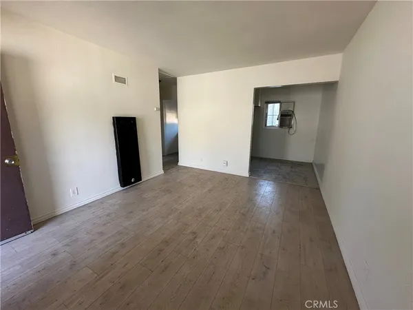 an empty room with closet and mirror