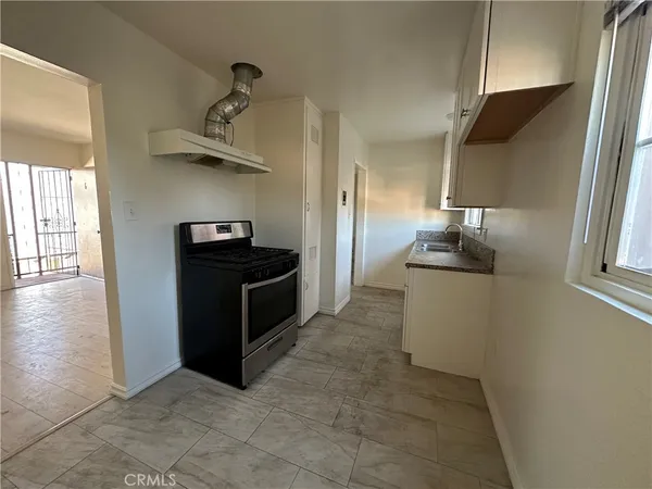 a kitchen with stainless steel appliances a stove and a refrigerator