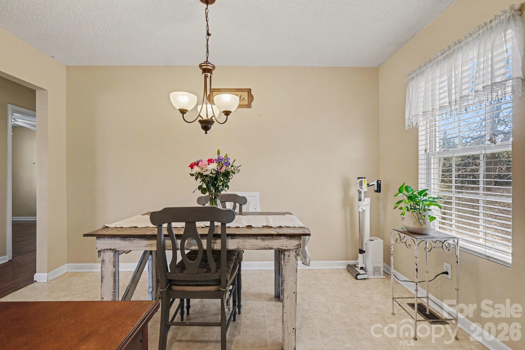 105 Chadwick Circle Dallas, NC 28034 - Photo 11 of 23 a dining room with chandelier and wooden floor