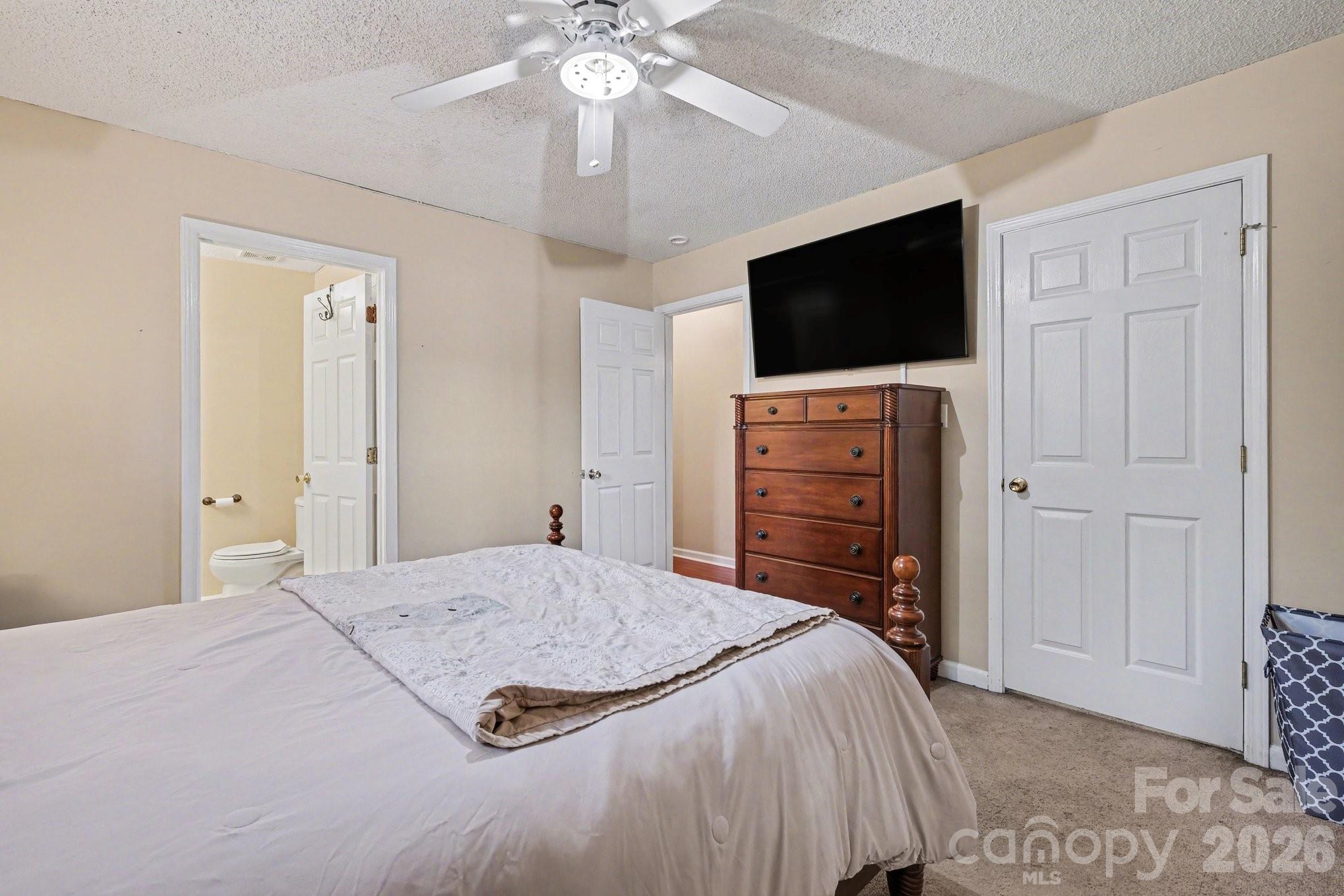 105 Chadwick Circle Dallas, NC 28034 - Photo 13 of 23 a bedroom with a bed and a flat screen tv