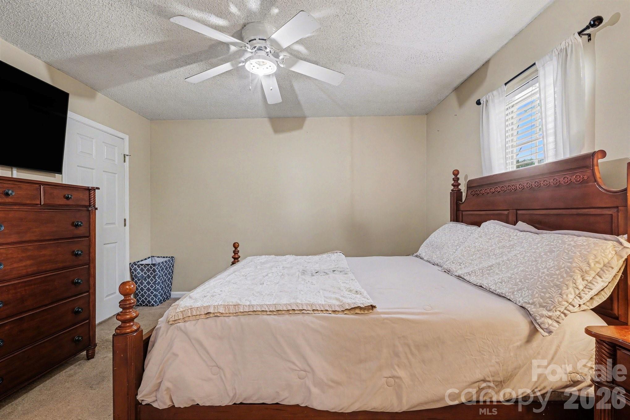 105 Chadwick Circle Dallas, NC 28034 - Photo 14 of 23 a bedroom with a bed and a flat screen tv