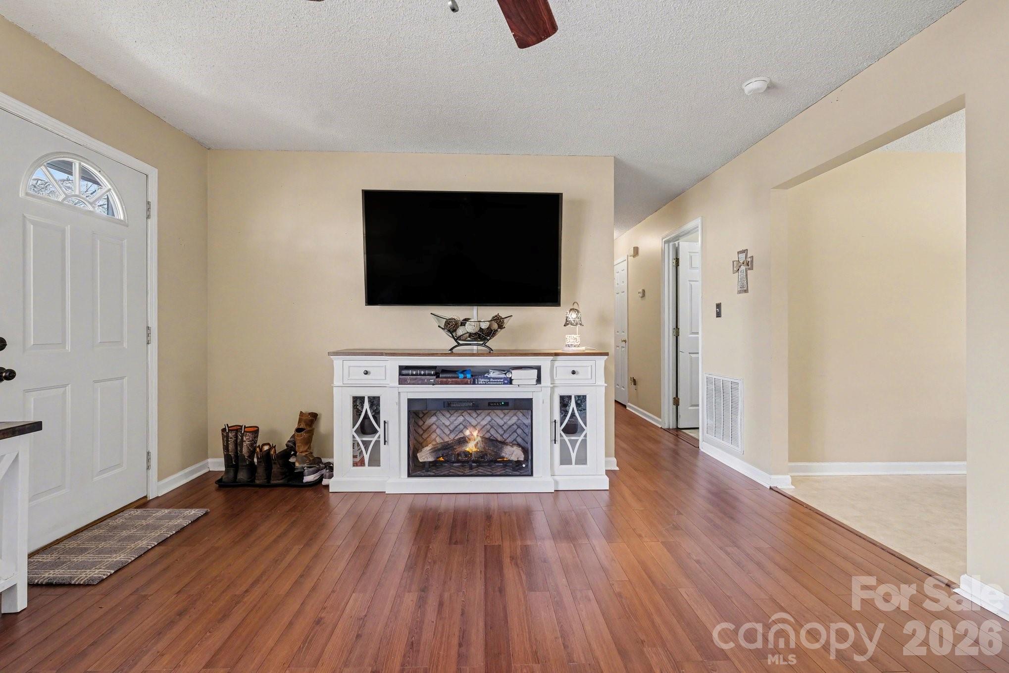 105 Chadwick Circle Dallas, NC 28034 - Photo 6 of 23 a living room with furniture a fireplace and a flat screen tv