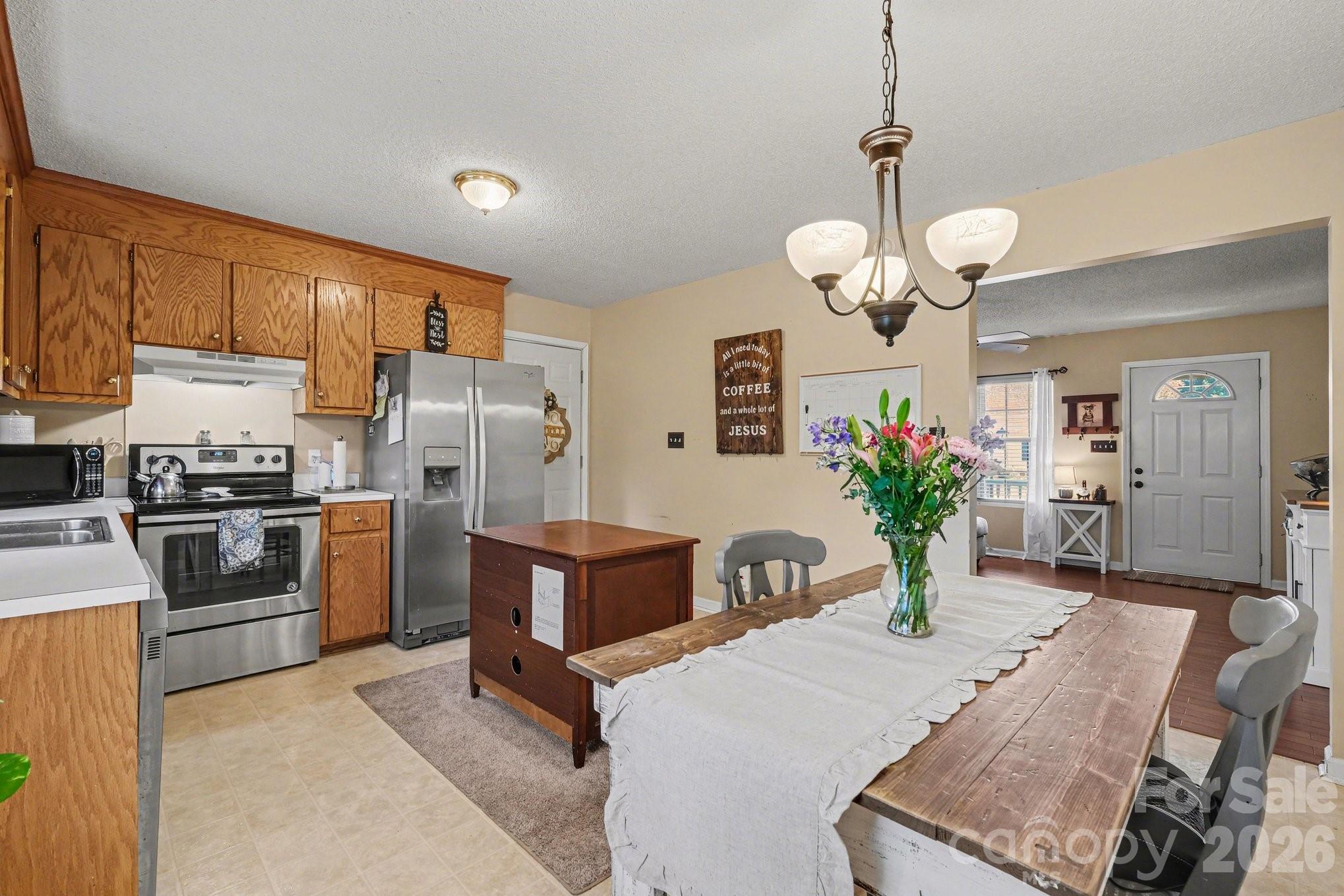 105 Chadwick Circle Dallas, NC 28034 - Photo 8 of 23 a kitchen with a table chairs refrigerator and microwave