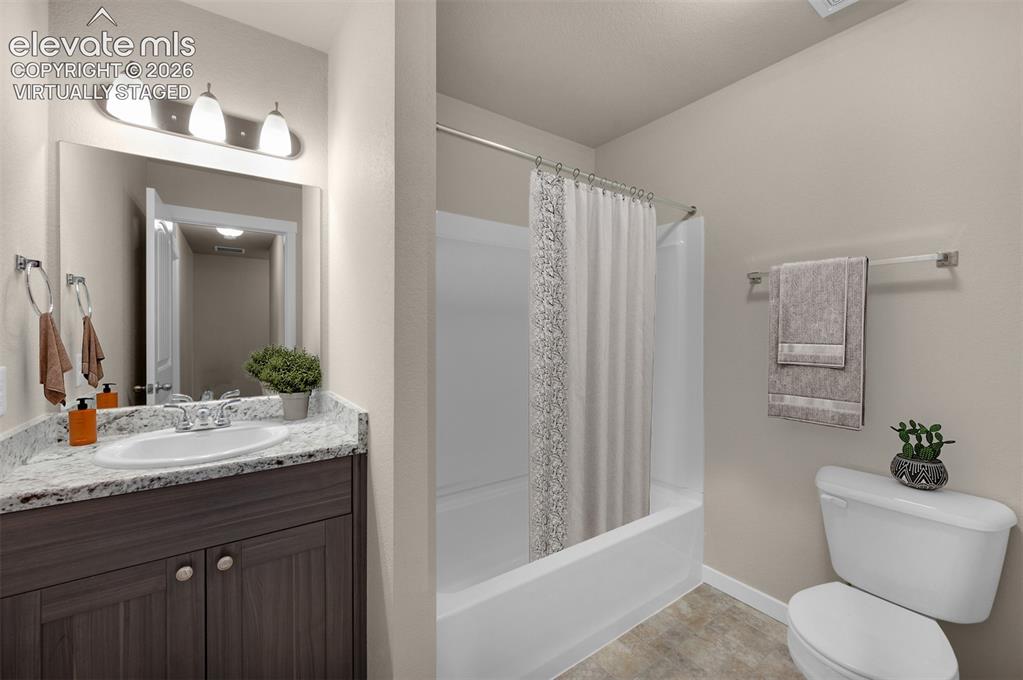 6644 Rawhide Rdg View Colorado Springs, CO 80915 - Photo 22 of 26 a bathroom with a granite countertop sink toilet and shower
