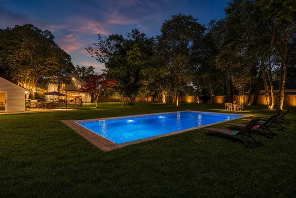 a view of yard with swimming pool and trees