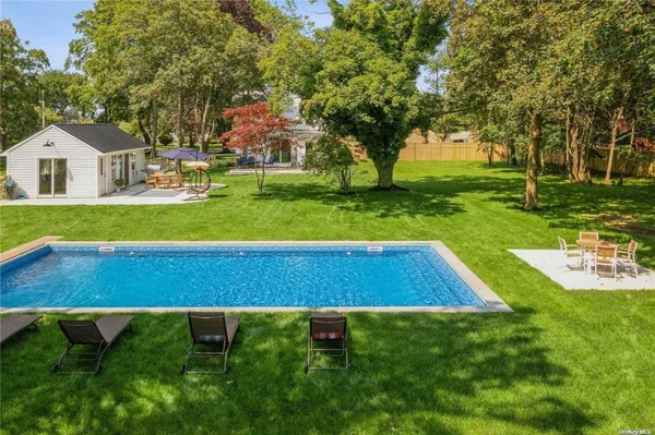 a view of yard with swimming pool and green space