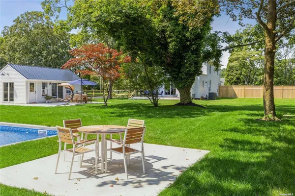 a view of a house with a yard porch and sitting area