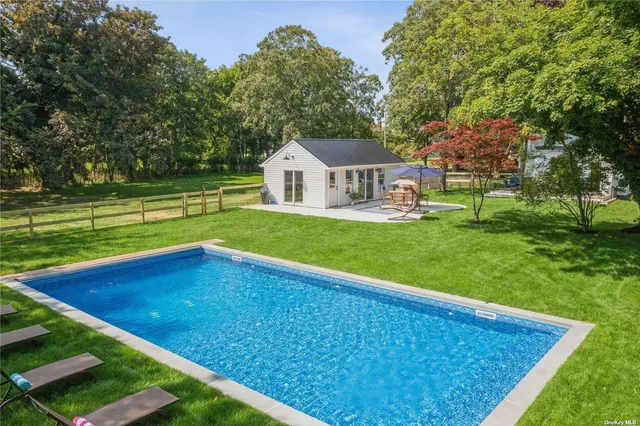 a view of pool with a house in the background