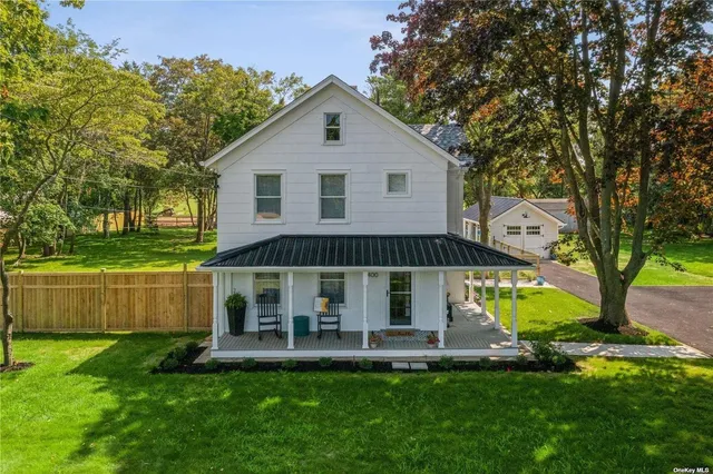 a view of a house with a yard patio and a garden