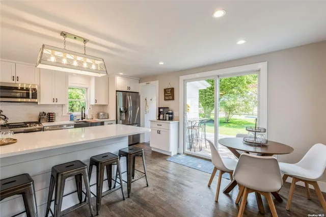a large kitchen with a table and chairs in it
