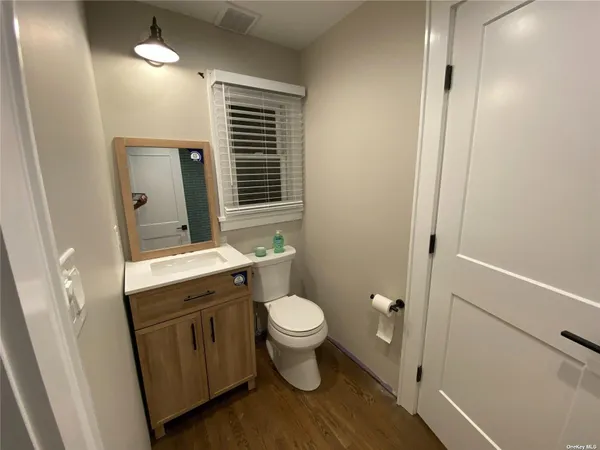 a bathroom with a toilet sink and mirror