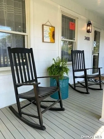 a view of a workspace room with furniture and wooden floor