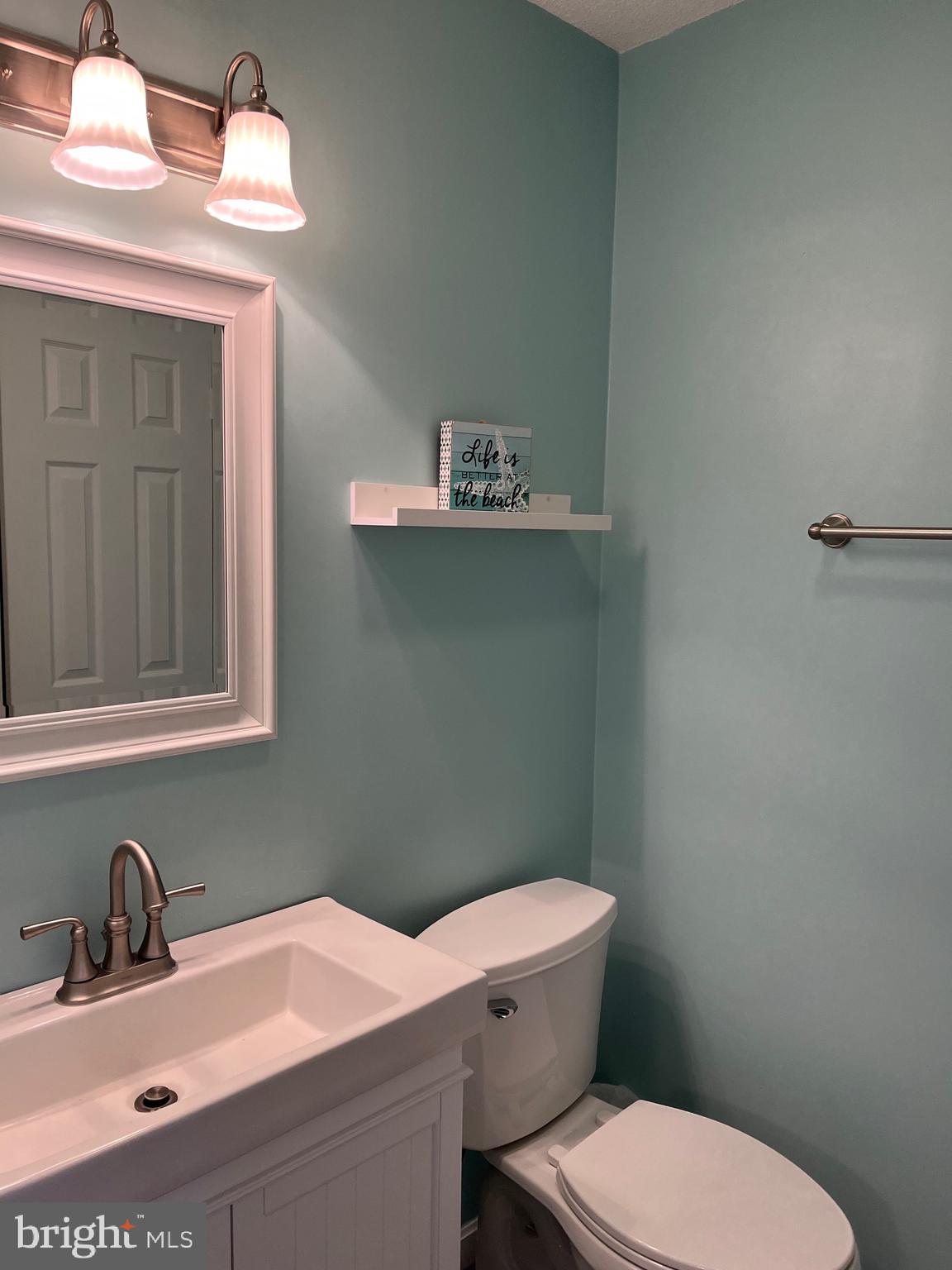14103 Derrickson Avenue Ocean City, MD 21842 - Photo 14 of 33 a bathroom with a sink a toilet and mirror