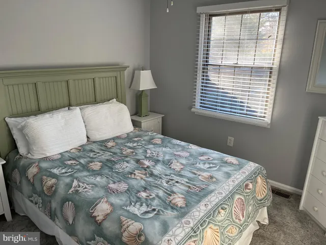 a bedroom with a bed and a lamp