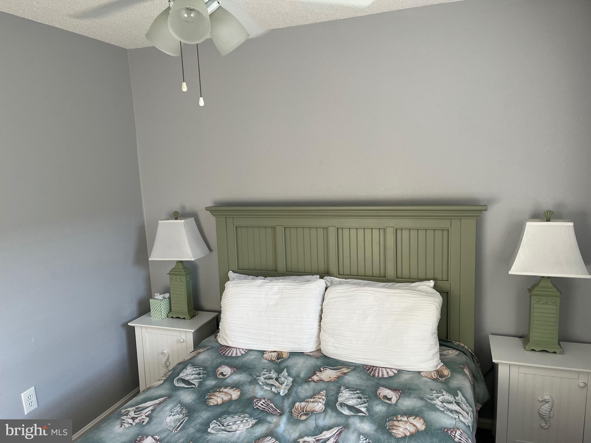 14103 Derrickson Avenue Ocean City, MD 21842 - Photo 16 of 33 a bedroom with a bed and a lamp