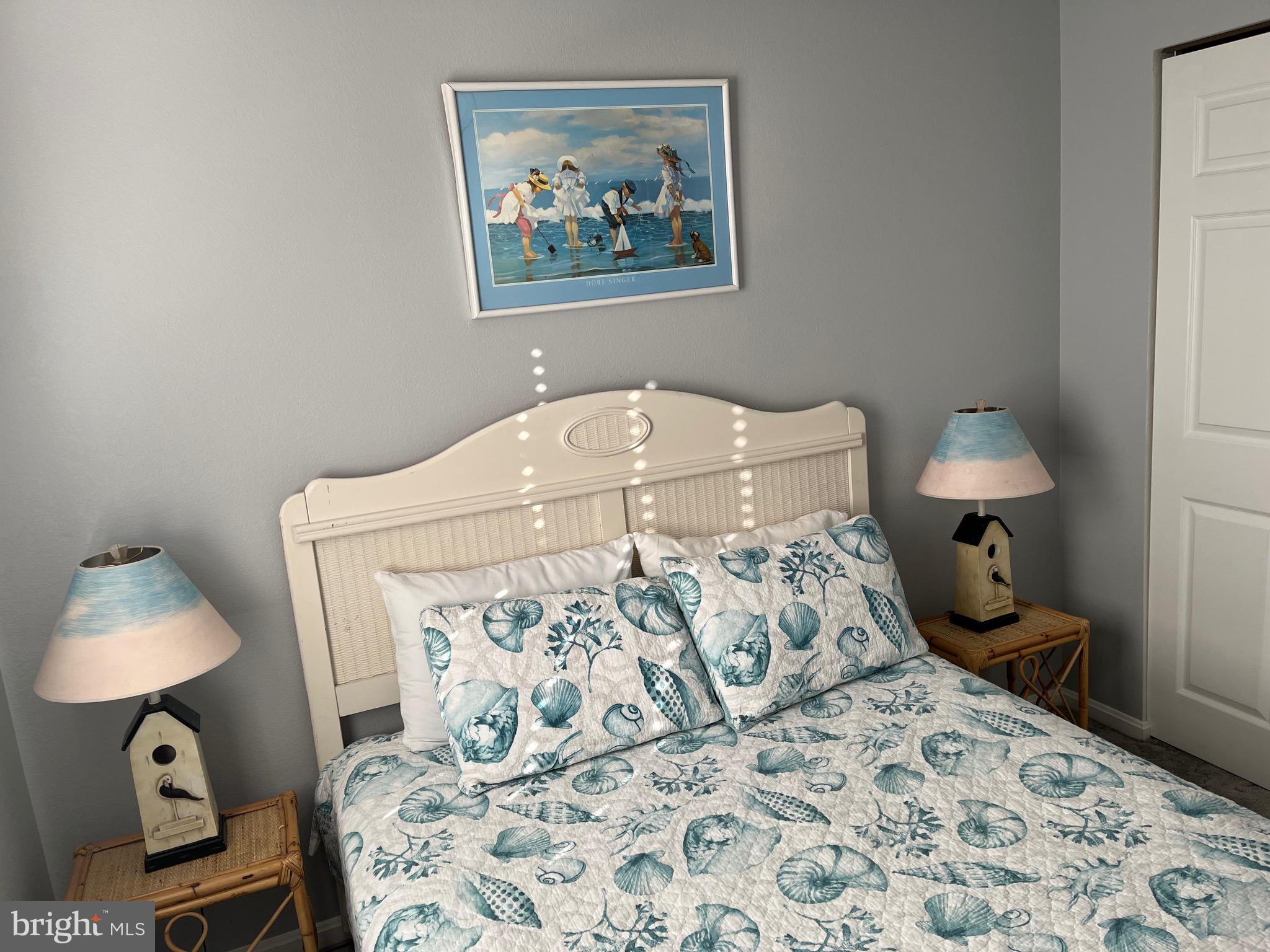 14103 Derrickson Avenue Ocean City, MD 21842 - Photo 17 of 33 a bedroom with a bed and a lamp