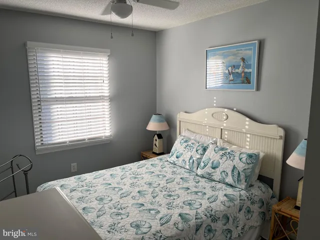 a bedroom with a bed and a lamp