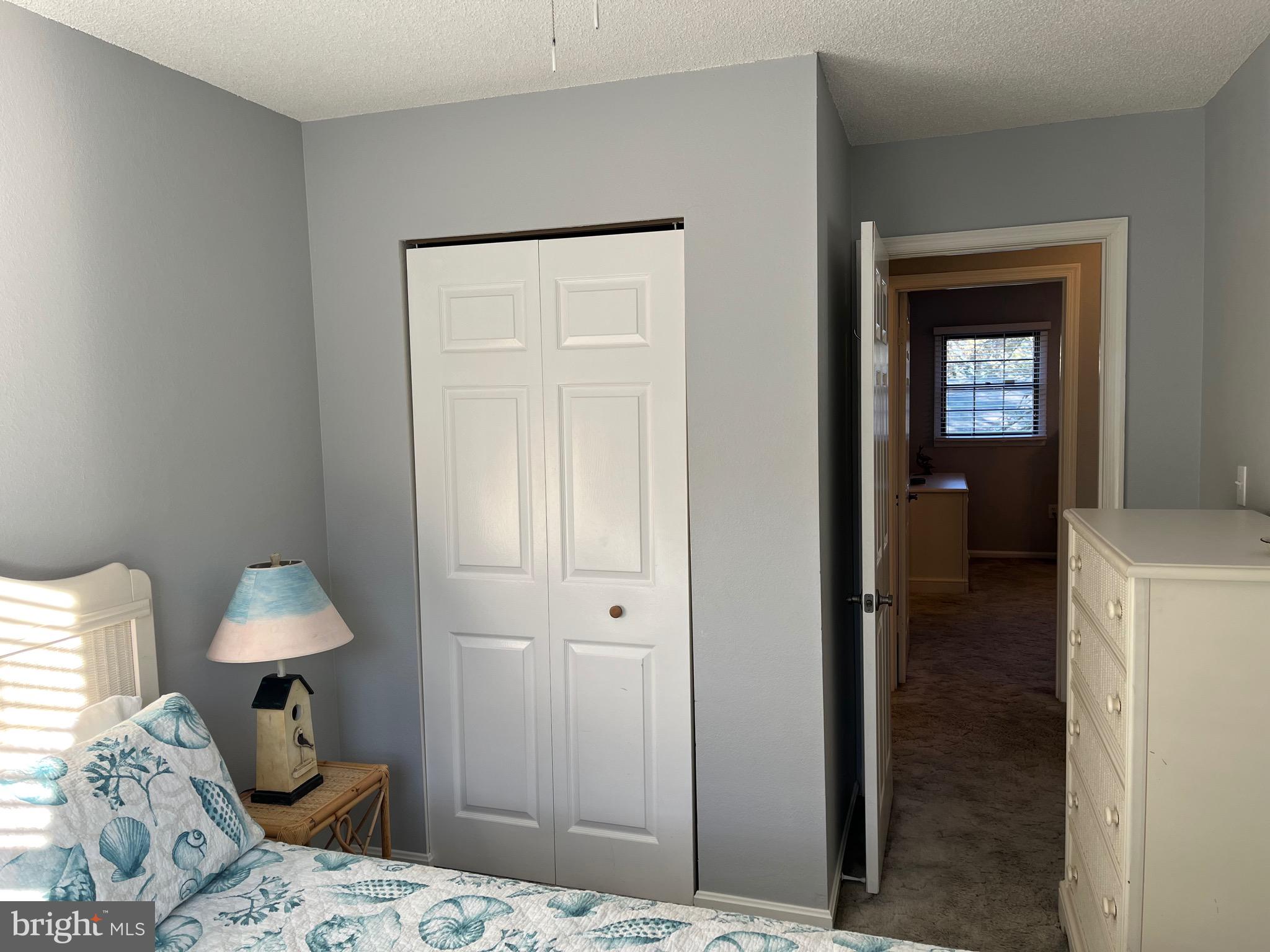 14103 Derrickson Avenue Ocean City, MD 21842 - Photo 19 of 33 a bedroom with a bed and a lamp