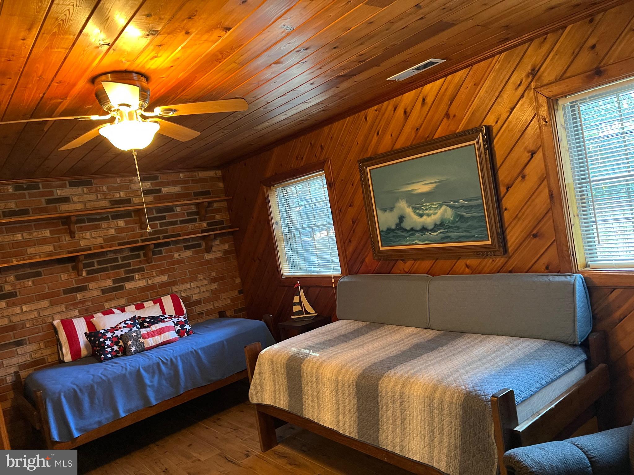 14103 Derrickson Avenue Ocean City, MD 21842 - Photo 24 of 33 a bedroom with a bed and a chandelier