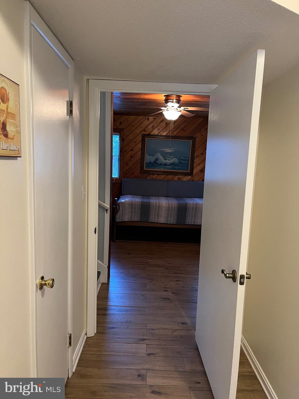 14103 Derrickson Avenue Ocean City, MD 21842 - Photo 29 of 33 a view of hall way with wooden floor and a fireplace
