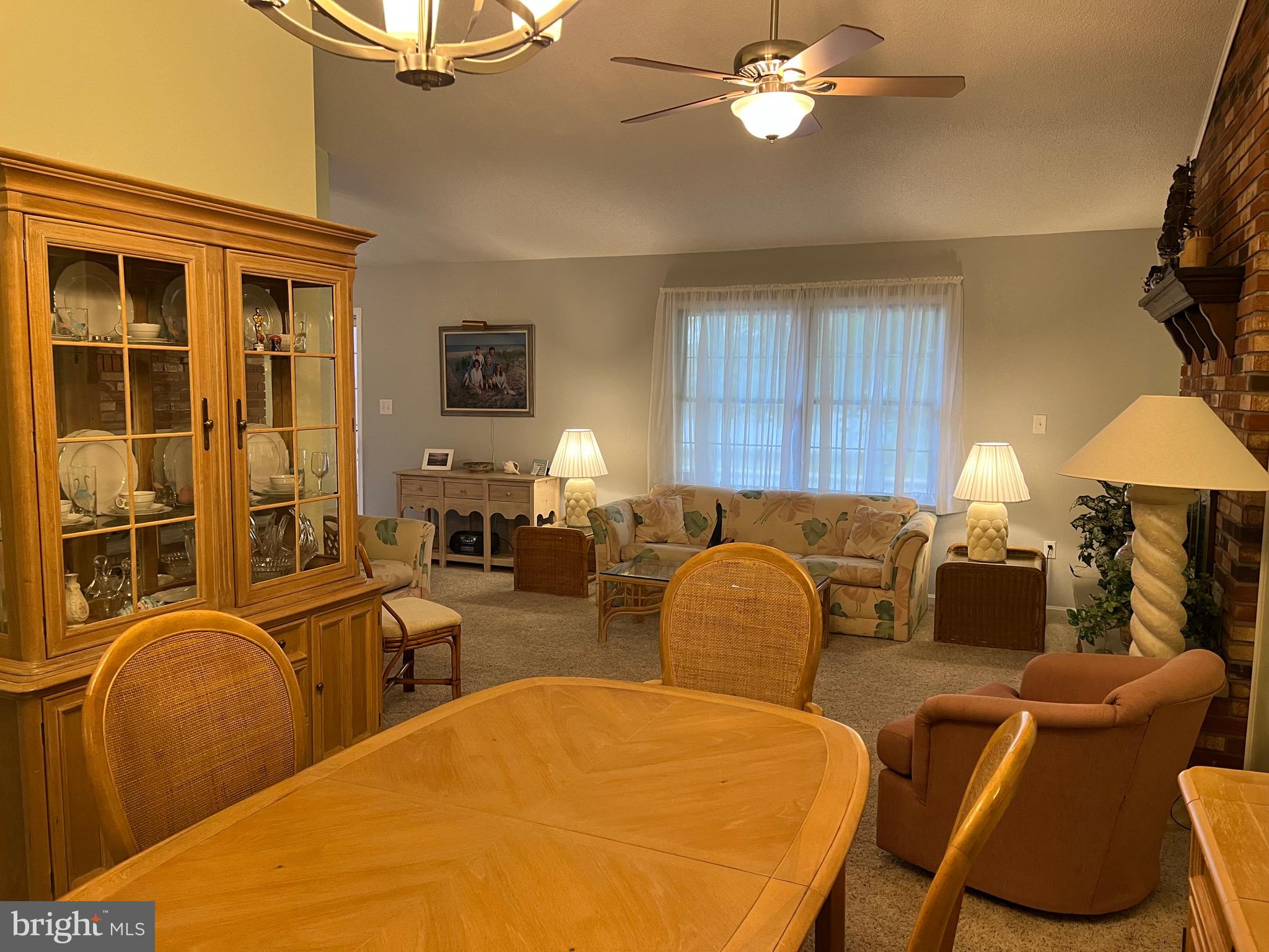14103 Derrickson Avenue Ocean City, MD 21842 - Photo 5 of 33 a living room with furniture a chandelier and a window