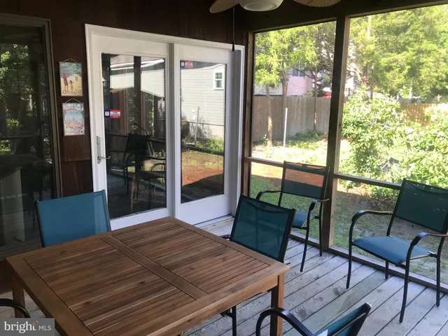 a backyard of a house with barbeque oven table and chairs