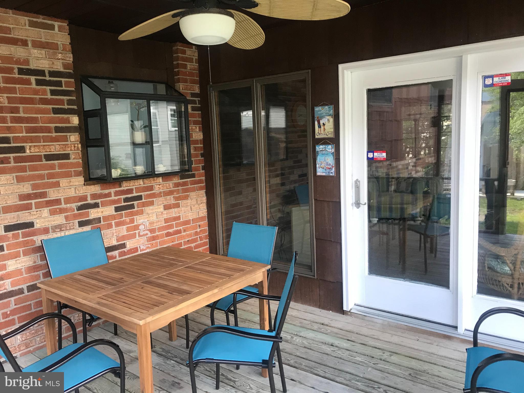 14103 Derrickson Avenue Ocean City, MD 21842 - Photo 10 of 33 a backyard of a house with barbeque oven table and chairs