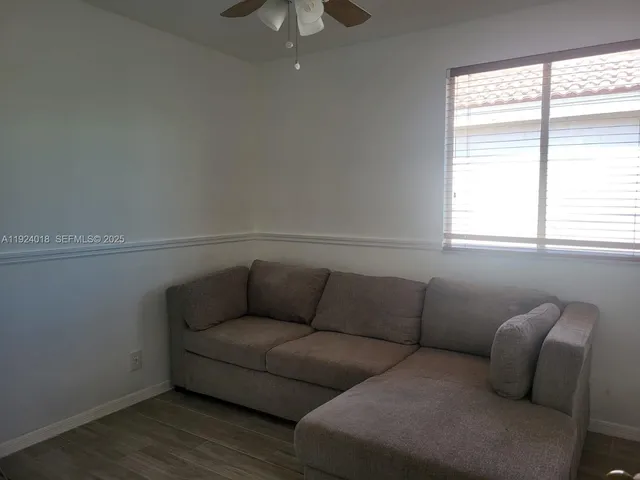 a living room with furniture and a window