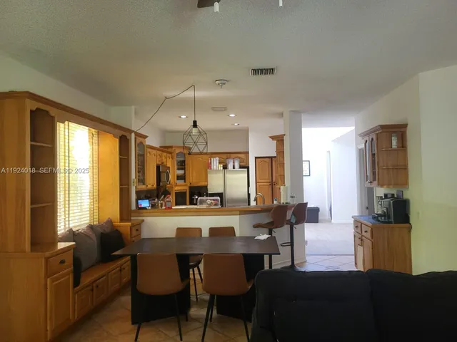 a view of a dining room with furniture and a large window