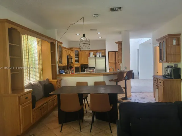a view of a dining room with furniture and window