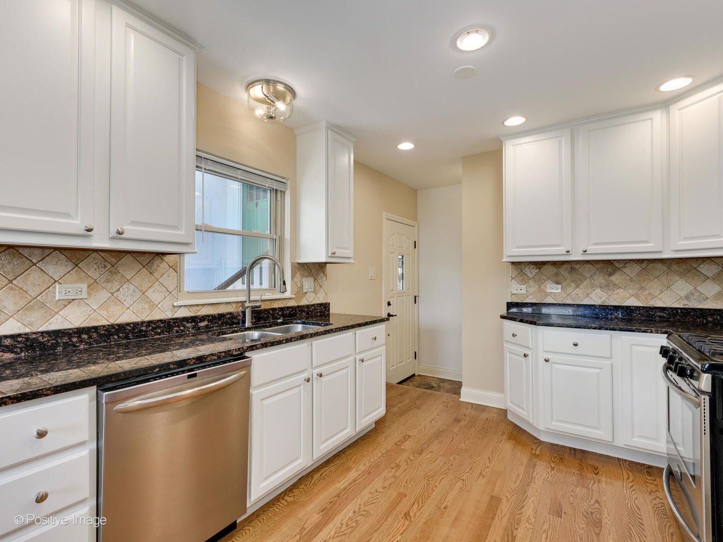 2420 Forest Avenue North Riverside, IL 60546 - Photo 6 of 28 a kitchen with granite countertop white cabinets and white appliances