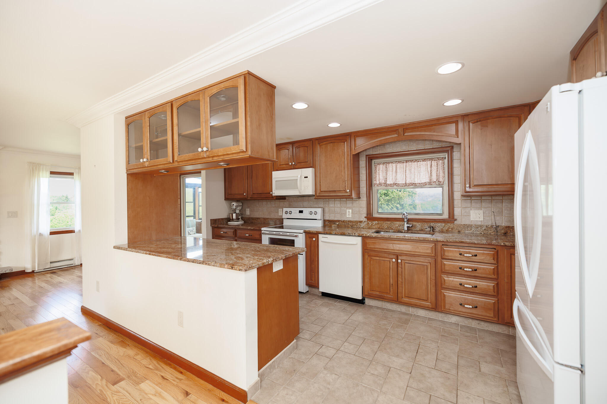 924 Hell Hollow Road Kunkletown, PA 18058 - Photo 21 of 60 a kitchen with stainless steel appliances granite countertop a stove top oven a sink dishwasher and a refrigerator with wooden floor