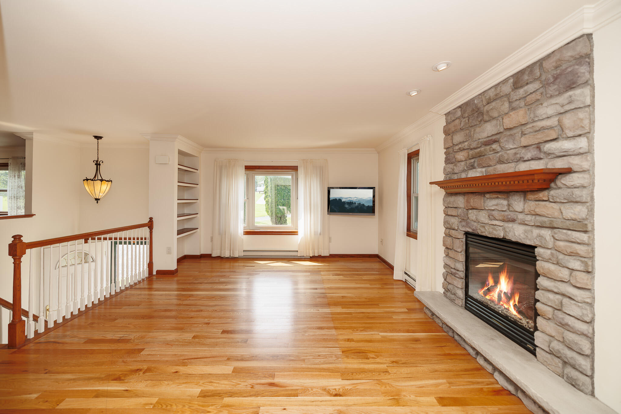 924 Hell Hollow Road Kunkletown, PA 18058 - Photo 34 of 60 a view of an empty room with wooden floor fireplace and a window