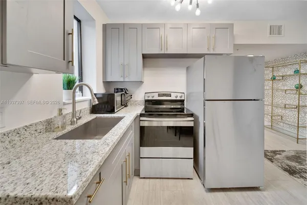 a kitchen with a refrigerator and a sink