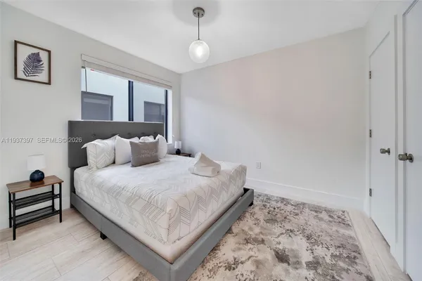 a bed room with a bed and a window