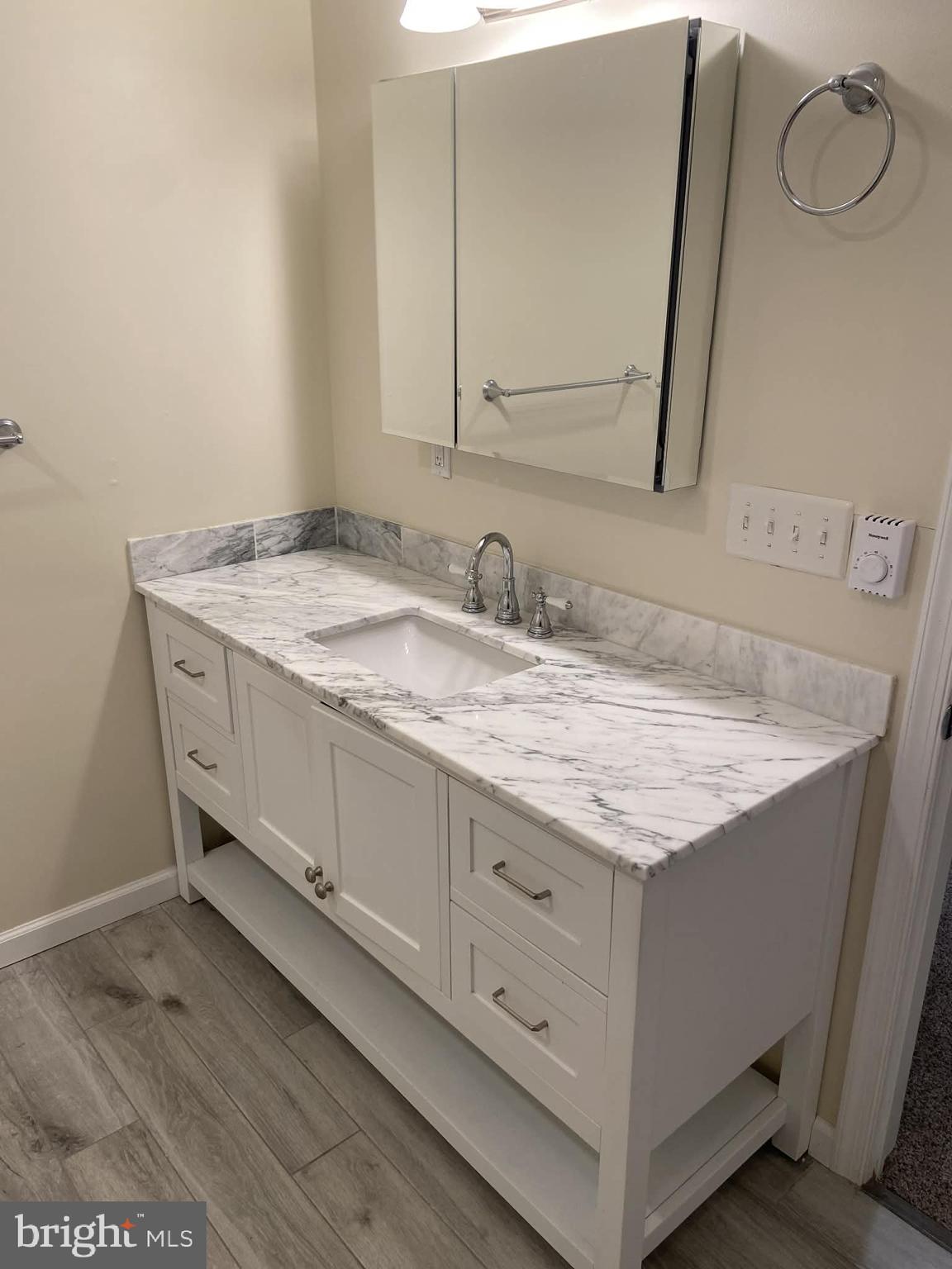 1416 East 5th Street Bethlehem, PA 18015 - Photo 17 of 26 a bathroom with a granite countertop sink and a mirror