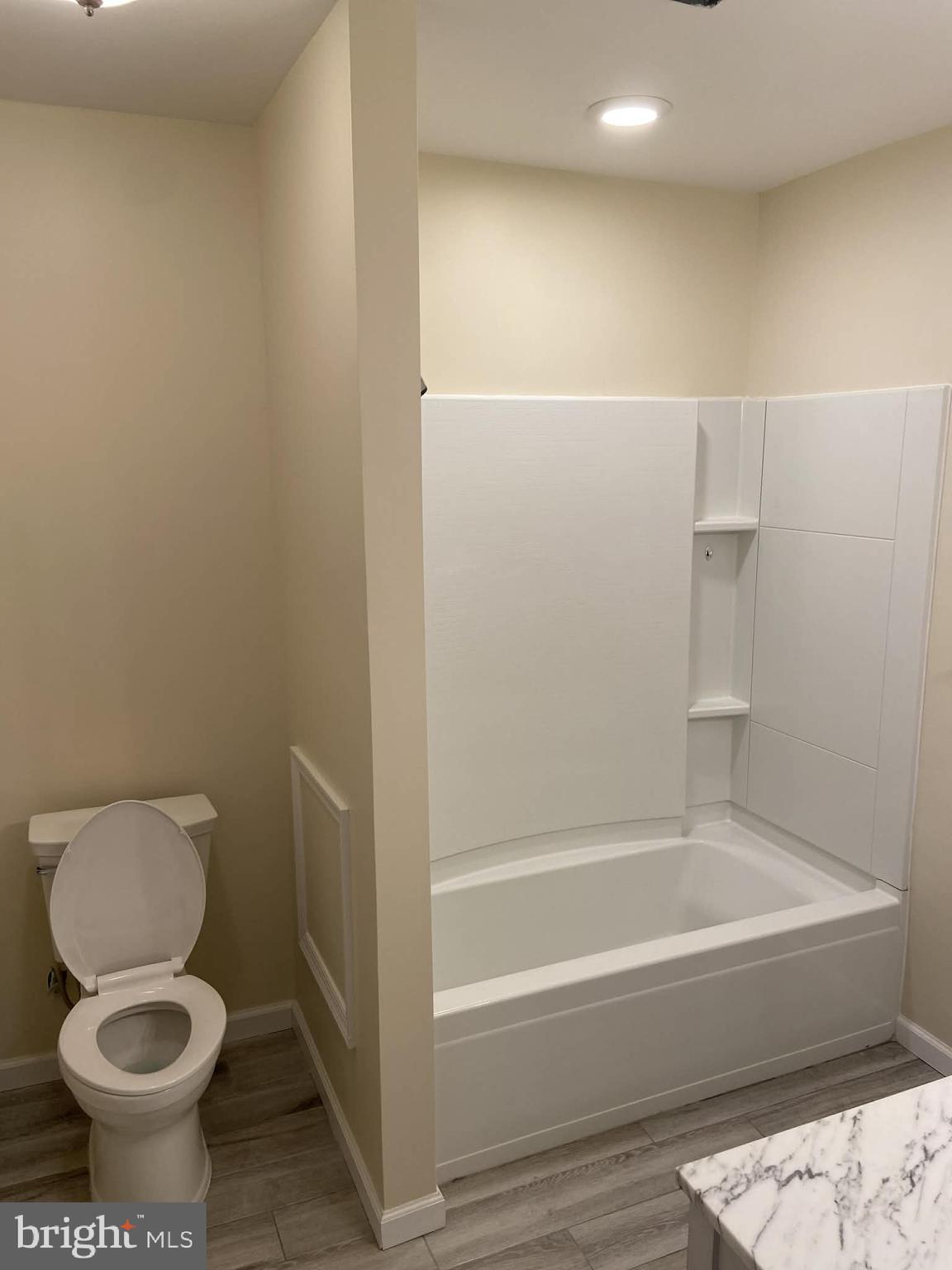 1416 East 5th Street Bethlehem, PA 18015 - Photo 18 of 26 a bathroom with a toilet and a bathtub